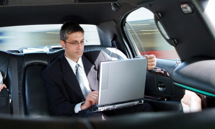 04A95503-1EAE-4C9A-93E2-CF52036E656A-799-000000EF4171A2DA A business professional working on a laptop in the back of an executive car service sedan in St. Louis
